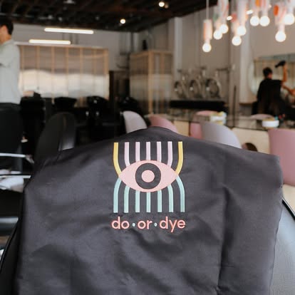 Branded salon cape with eye motif