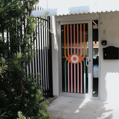 Front entrance with eye-motif window decal