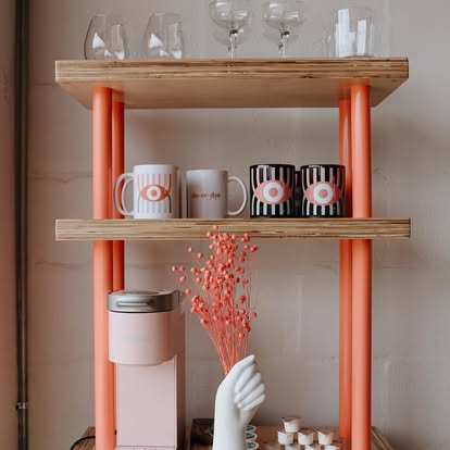 Branded coffee bar with eye-motif mugs